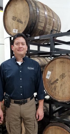 Luis standing by Rye filled barrels at Rum Central.jpg